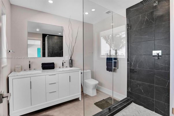 Bathroom, Dual Sink Vanities, Glass Shower, Interior, Marble Walls, Recessed Lighting, Washer