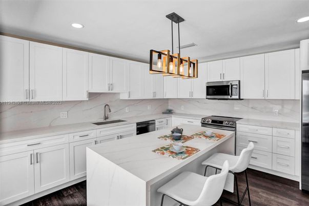 Interior, Kitchen, Marble Walls, Pendant Lights, Recessed Lighting, Stainless Steel Appliances, Wood Texture Flooring