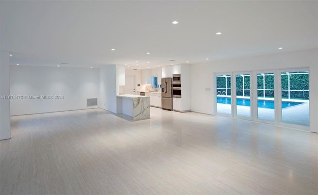 Empty room, Interior, Kitchen, Recessed Lighting, Stainless Steel Appliances, Wood Texture Flooring