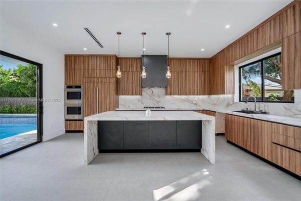 Interior, Kitchen, Marble Walls, Pendant Lights, Recessed Lighting, Stainless Steel Appliances