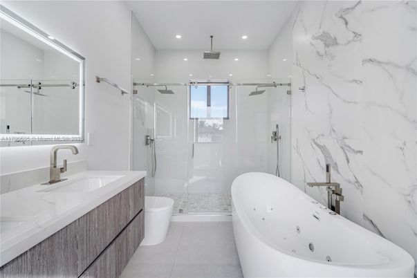 Bathroom, Dual Sink Vanities, Free Standing Baths, Glass Shower, Interior, Marble Walls, Recessed Lighting