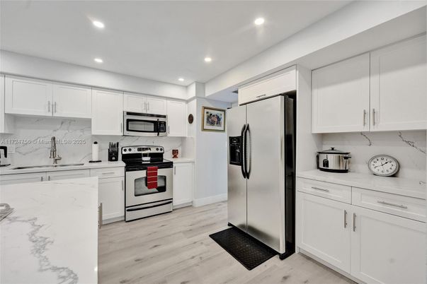 Interior, Kitchen, Marble Walls, Recessed Lighting, Stainless Steel Appliances, Wood Texture Flooring