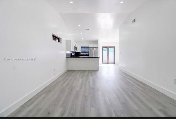 Empty room, Interior, Kitchen, Recessed Lighting, Stainless Steel Appliances, Wood Texture Flooring