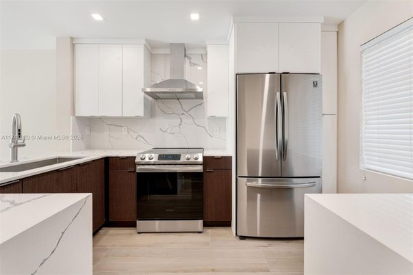 Interior, Kitchen, Marble Walls, Recessed Lighting, Stainless Steel Appliances, Wood Texture Flooring