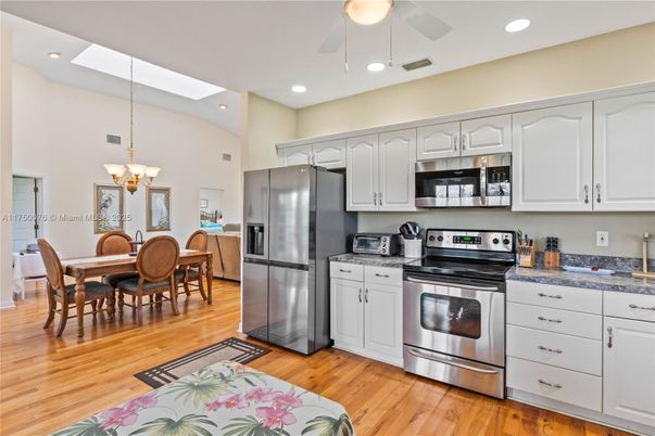Chandelier, Dining room, Interior, Kitchen, Recessed Lighting, Stainless Steel Appliances, Wood Texture Flooring