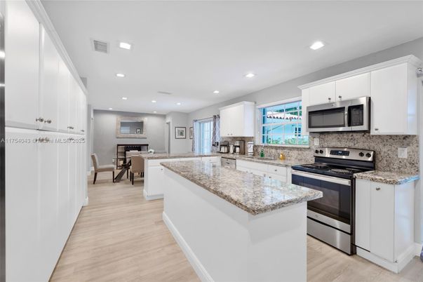 Dining room, Interior, Kitchen, Recessed Lighting, Stainless Steel Appliances, Wood Texture Flooring