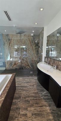 Bathroom, Dual Sink Vanities, Free Standing Baths, Glass Shower, Interior, Marble Walls, Recessed Lighting, Wood Texture Flooring