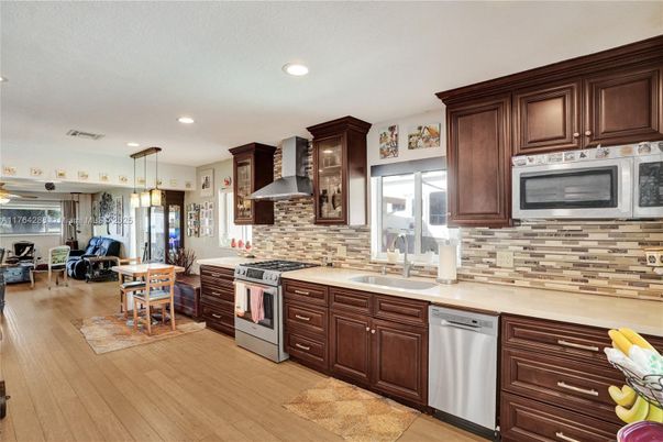 Dining room, Interior, Kitchen, Pendant Lights, Recessed Lighting, Stainless Steel Appliances, Wood Texture Flooring
