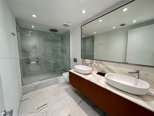 Bathroom, Dual Sink Vanities, Glass Shower, Interior, Marble, Marble Walls, Recessed Lighting