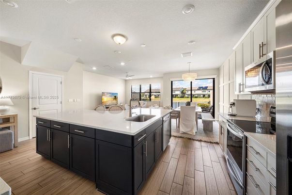 Chandelier, Dining room, Interior, Kitchen, Pendant Lights, Recessed Lighting, Stainless Steel Appliances, Wood Texture Flooring