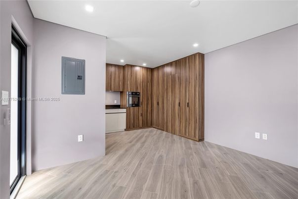 Empty room, Interior, Kitchen, Recessed Lighting, Stainless Steel Appliances, Wood Texture Flooring