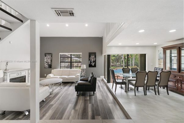 Dining room, Fireplace, Interior, Living room, Recessed Lighting, Wood Texture Flooring