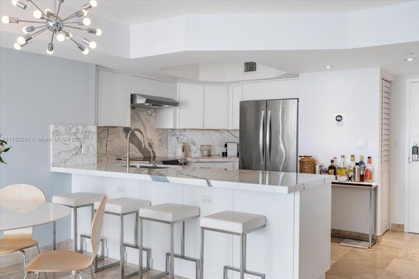 Interior, Kitchen, Marble Walls, Pendant Lights, Recessed Lighting, Stainless Steel Appliances