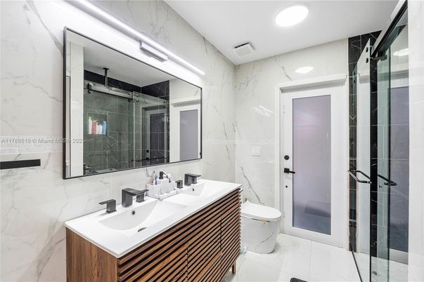 Bathroom, Dual Sink Vanities, Glass Shower, Interior, Marble, Marble Walls, Recessed Lighting