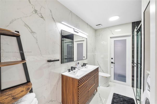 Bathroom, Dual Sink Vanities, Glass Shower, Interior, Marble, Marble Walls, Recessed Lighting