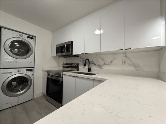 Interior, Kitchen, Marble Walls, Recessed Lighting, Washer, Wood Texture Flooring
