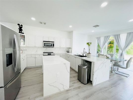 Interior, Kitchen, Marble Walls, Recessed Lighting, Stainless Steel Appliances, Wood Texture Flooring