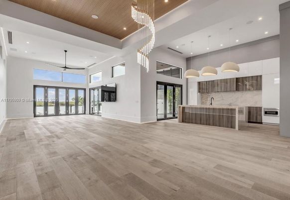 Chandelier, Interior, Kitchen, Marble Walls, Pendant Lights, Recessed Lighting, Stainless Steel Appliances, Wood Texture Flooring