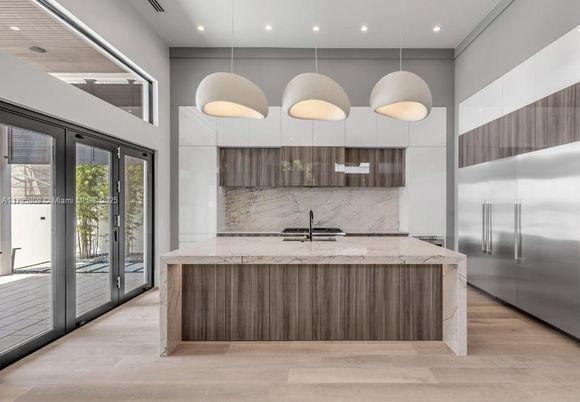 Interior, Kitchen, Marble Walls, Pendant Lights, Recessed Lighting, Stainless Steel Appliances, Wood Texture Flooring