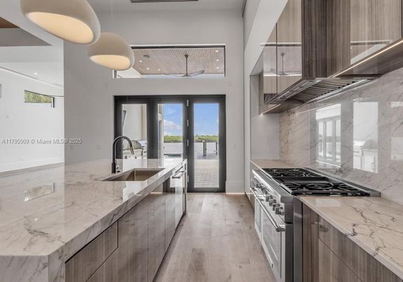 Interior, Kitchen, Marble Walls, Recessed Lighting, Stainless Steel Appliances, Wood Texture Flooring