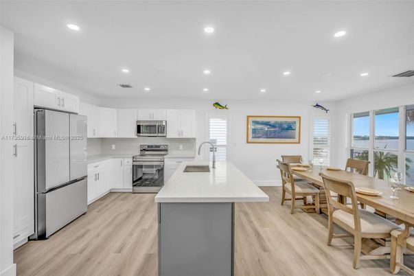 Dining room, Interior, Kitchen, Recessed Lighting, Stainless Steel Appliances, Wood Texture Flooring