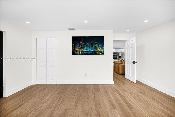 Empty room, Interior, Kitchen, Recessed Lighting, Stainless Steel Appliances, Wood Texture Flooring