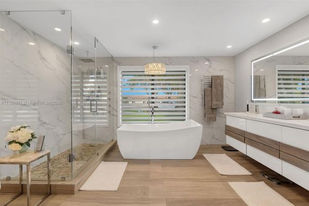 Bathroom, Free Standing Baths, Glass Shower, Interior, Marble Walls, Pendant Lights, Recessed Lighting, Wood Texture Flooring