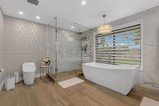 Bathroom, Free Standing Baths, Glass Shower, Interior, Marble Walls, Recessed Lighting, Wood Texture Flooring