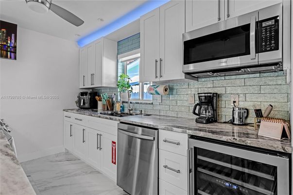 Interior, Kitchen, Marble, Recessed Lighting, Stainless Steel Appliances, Stone Walls