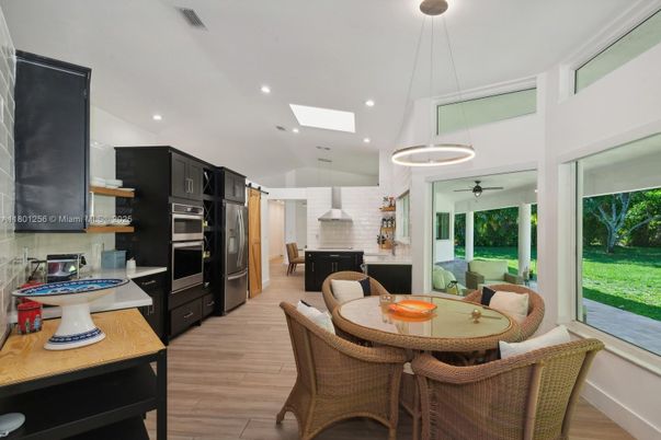 Dining room, Fireplace, Interior, Kitchen, Pendant Lights, Recessed Lighting, Stainless Steel Appliances, Stone Walls, Wood Texture Flooring