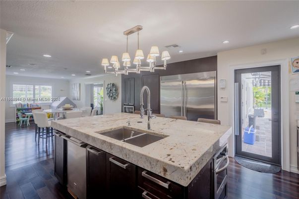 Chandelier, Dining room, Interior, Kitchen, Pendant Lights, Recessed Lighting, Stainless Steel Appliances, Wood Texture Flooring