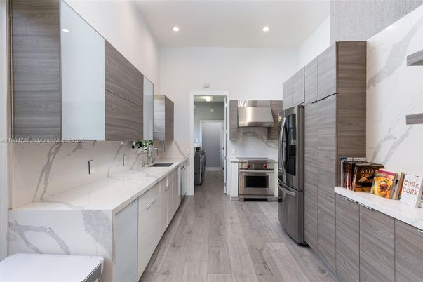 Interior, Kitchen, Marble Walls, Recessed Lighting, Stainless Steel Appliances, Wood Texture Flooring