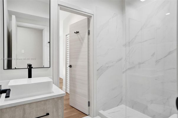 Bathroom, Glass Shower, Interior, Marble Walls, Wood Texture Flooring