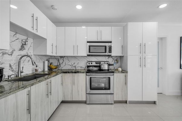 Interior, Kitchen, Marble Walls, Recessed Lighting, Stainless Steel Appliances