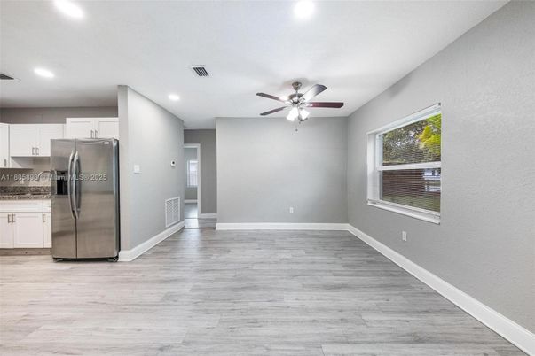 Empty room, Interior, Kitchen, Recessed Lighting, Stainless Steel Appliances, Wood Texture Flooring