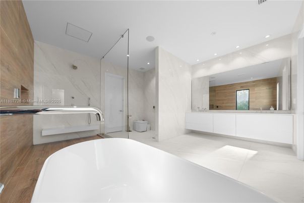 Bathroom, Dual Sink Vanities, Free Standing Baths, Glass Shower, Interior, Marble Walls, Recessed Lighting, Wood Texture Flooring