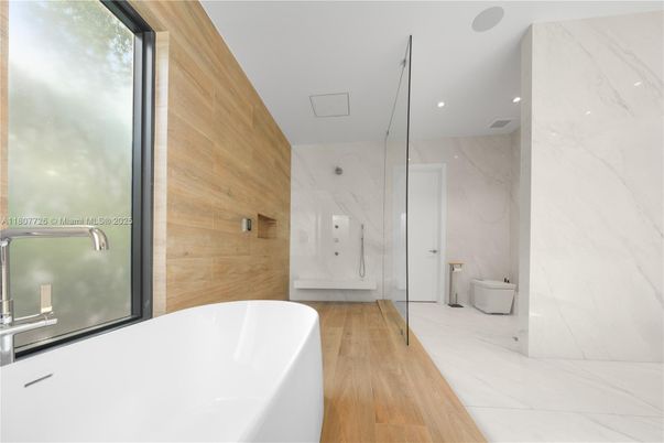 Bathroom, Free Standing Baths, Interior, Marble Walls, Recessed Lighting, Wood Texture Flooring, Wooden Walls