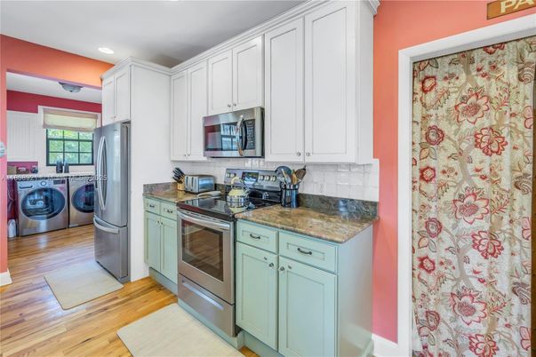 Interior, Kitchen, Recessed Lighting, Washer, Wood Texture Flooring