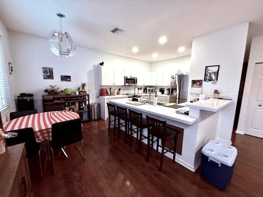 Dining room, Interior, Kitchen, Pendant Lights, Recessed Lighting, Stainless Steel Appliances, Wood Texture Flooring