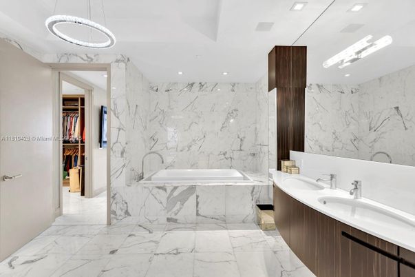 Bathroom, Dual Sink Vanities, Interior, Marble, Marble Walls, Pendant Lights, Recessed Lighting