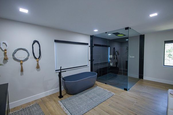 Bathroom, Free Standing Baths, Glass Shower, Interior, Projection Screen, Recessed Lighting, Wood Texture Flooring