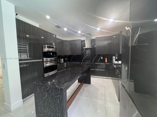Interior, Kitchen, Marble Walls, Recessed Lighting, Stainless Steel Appliances