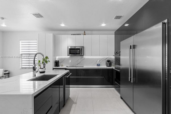 Interior, Kitchen, Marble Walls, Recessed Lighting, Stainless Steel Appliances