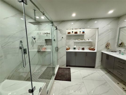 Bathroom, Dual Sink Vanities, Glass Shower, Interior, Marble, Marble Walls, Recessed Lighting