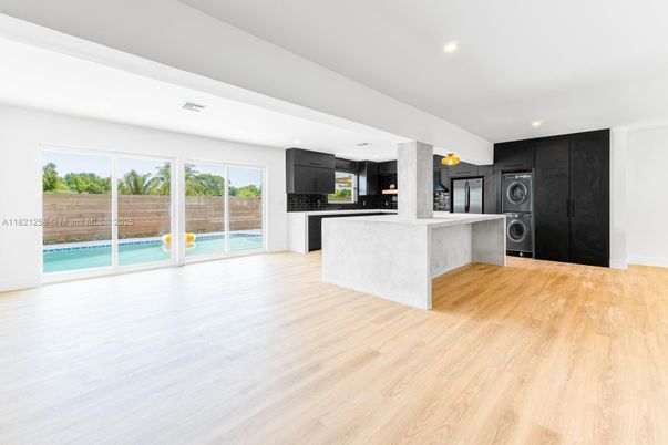Interior, Kitchen, Recessed Lighting, Washer, Wood Texture Flooring