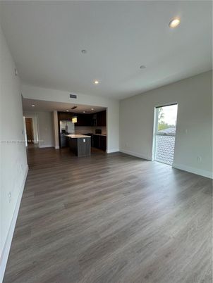Empty room, Interior, Kitchen, Recessed Lighting, Stainless Steel Appliances, Wood Texture Flooring