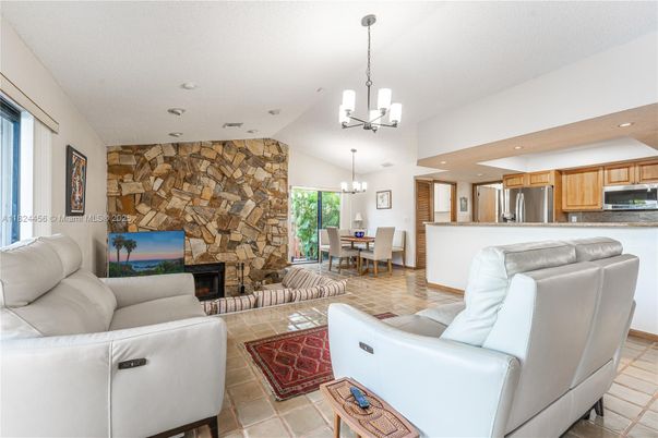 Chandelier, Dining room, Fireplace, Interior, Kitchen, Living room, Pendant Lights, Recessed Lighting, Stainless Steel Appliances, Stone Walls