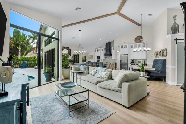 Chandelier, Interior, Kitchen, Living room, Pendant Lights, Recessed Lighting, Stainless Steel Appliances, Wooden Beams, Wood Texture Flooring