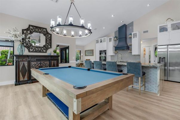 Billiard Table, Chandelier, Game Room, Interior, Kitchen, Pendant Lights, Recessed Lighting, Stainless Steel Appliances, Wood Texture Flooring