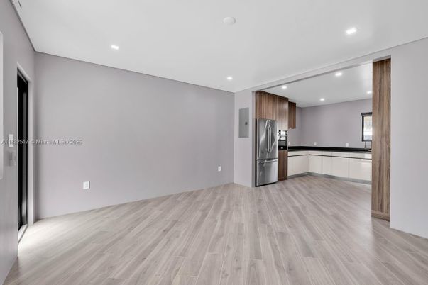 Empty room, Interior, Kitchen, Recessed Lighting, Stainless Steel Appliances, Wood Texture Flooring